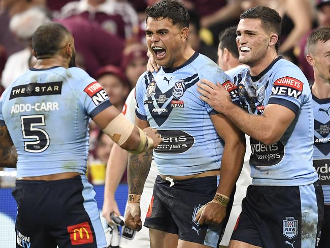 TOWNSVILLE, AUSTRALIA - JUNE 09:  Latrell Mitchell of the Blues celebrates with team mates after scoring a try during game one of the 2021 State of Origin series between the New South Wales Blues and the Queensland Maroons at Queensland Country Bank Stadium on June 09, 2021 in Townsville, Australia. (Photo by Ian Hitchcock/Getty Images)