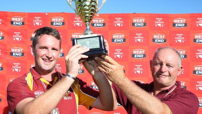 Peter Sleep lifts the grade cricket Twenty20 trophy with now Tea Tree Gully player/coach Matt Weaver in 2016. Picture: Stephen Laffer