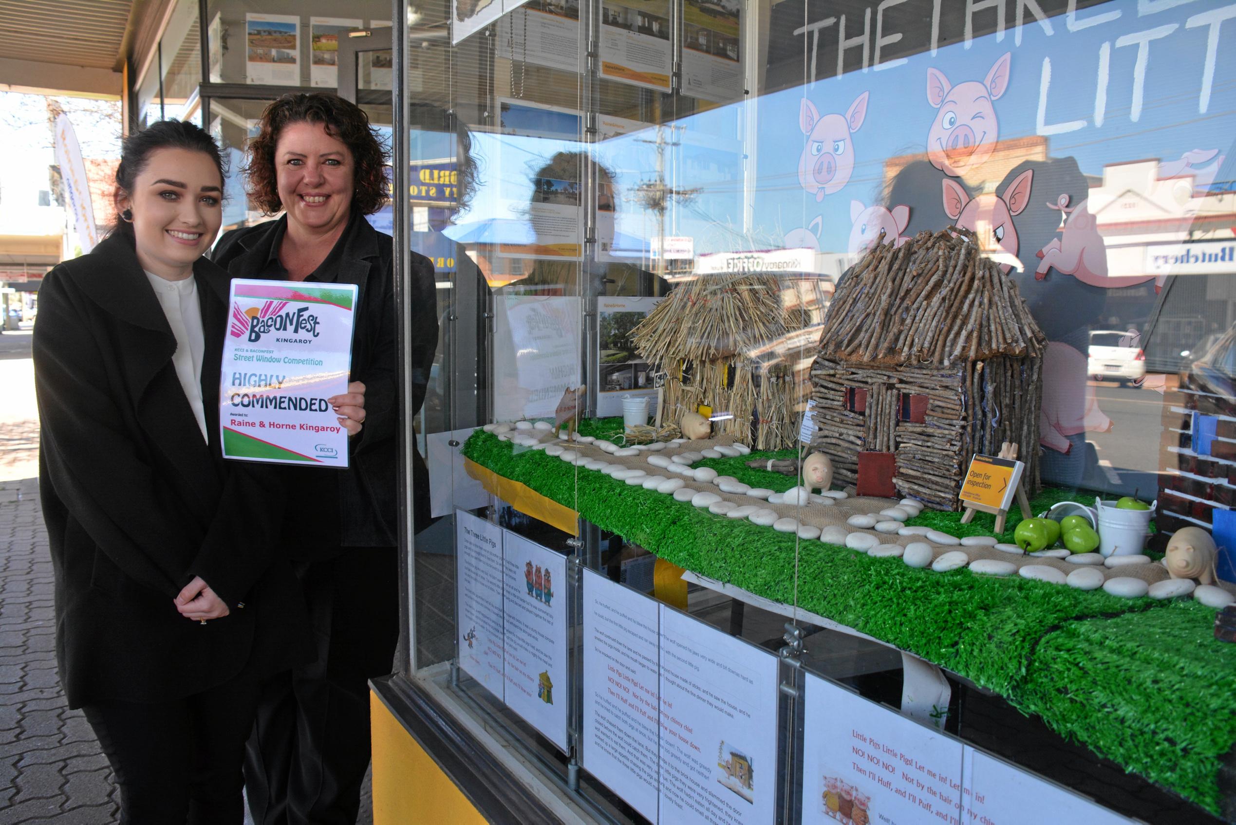 Raine&Horne Kingaroy's Chloe Dennis and Vickie Bells outside their BaconFest street window display of the three little pigs, earning them a highly commended. Picture: Jessica McGrath