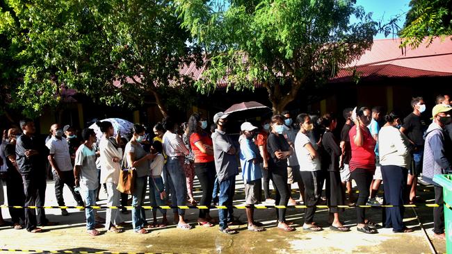 People queue to cast their ballot during the second round of the presidential election in Dili, East Timor, on April 19.