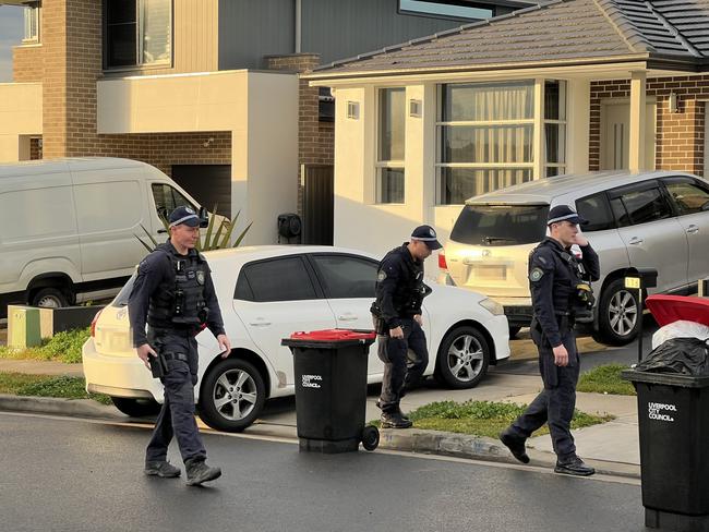 Detectives searching the area for potential weapons. Picture: Emily Kowal