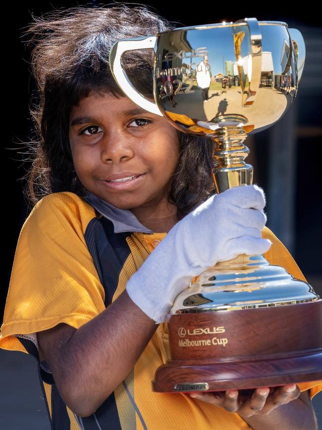 Paula Namie, 8, holds the Cup as it visits Cloncurry State School in Queensland. Picture: Jay Town