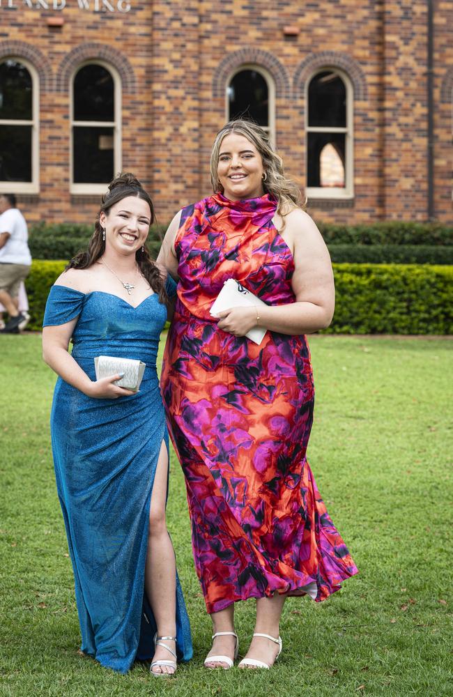 Graduates Chelsea Welsh (left) and Trinity Rouhead as Downlands College year 12 students come together for their valedictory mass at the college, Saturday, November 16, 2024. Picture: Kevin Farmer