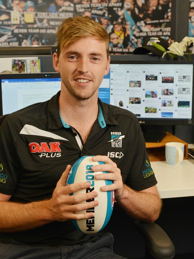 East Torrens all-rounder Michael Cranmer working in the Port Adelaide Football Club media department. Picture: AAP/Brenton Edwards