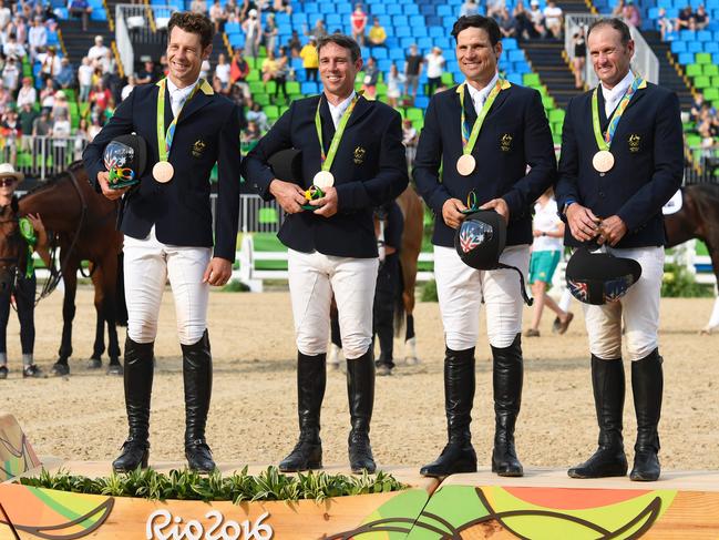 Australia's Christopher Burton, Australia's Sam Griffiths, Australia's Shane Rose and Australia's Stuart Tinney celebrate with thir bronze medals on the podium during the women's team final Artistic Gymnastics at the Olympic Arena during the Rio 2016 Olympic Games in Rio de Janeiro on August 9, 2016. / AFP PHOTO / John MACDOUGALL