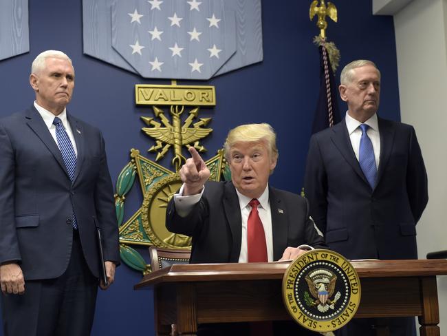 President Donald Trump, center, gestures after signing two executive action at the Pentagon in Washington, Friday, Jan. 27, 2017, with Vice President Mike Pence, left, and Defense Secretary James Mattis, right, at his side. (AP Photo/Susan Walsh)