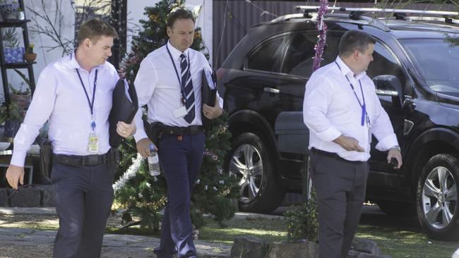 Detectives speak to residents at a property where the altercation began. Picture: Tony Gough