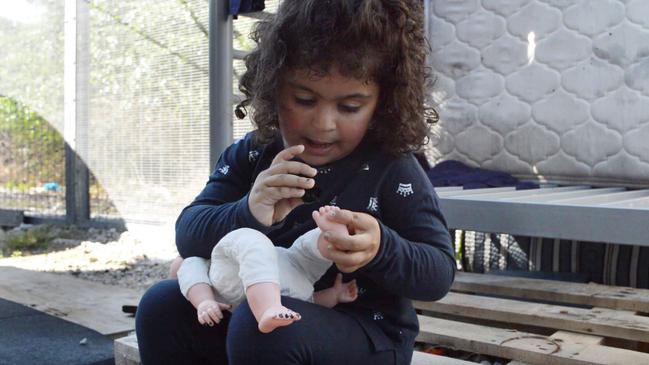 Melanie with her doll. Picture: World Vision Australia