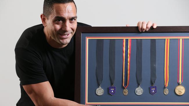 Former Adelaide Crows star Andrew McLeod with his AFL medals, including two Norm Smith Medals. Picture: Calum Robertson