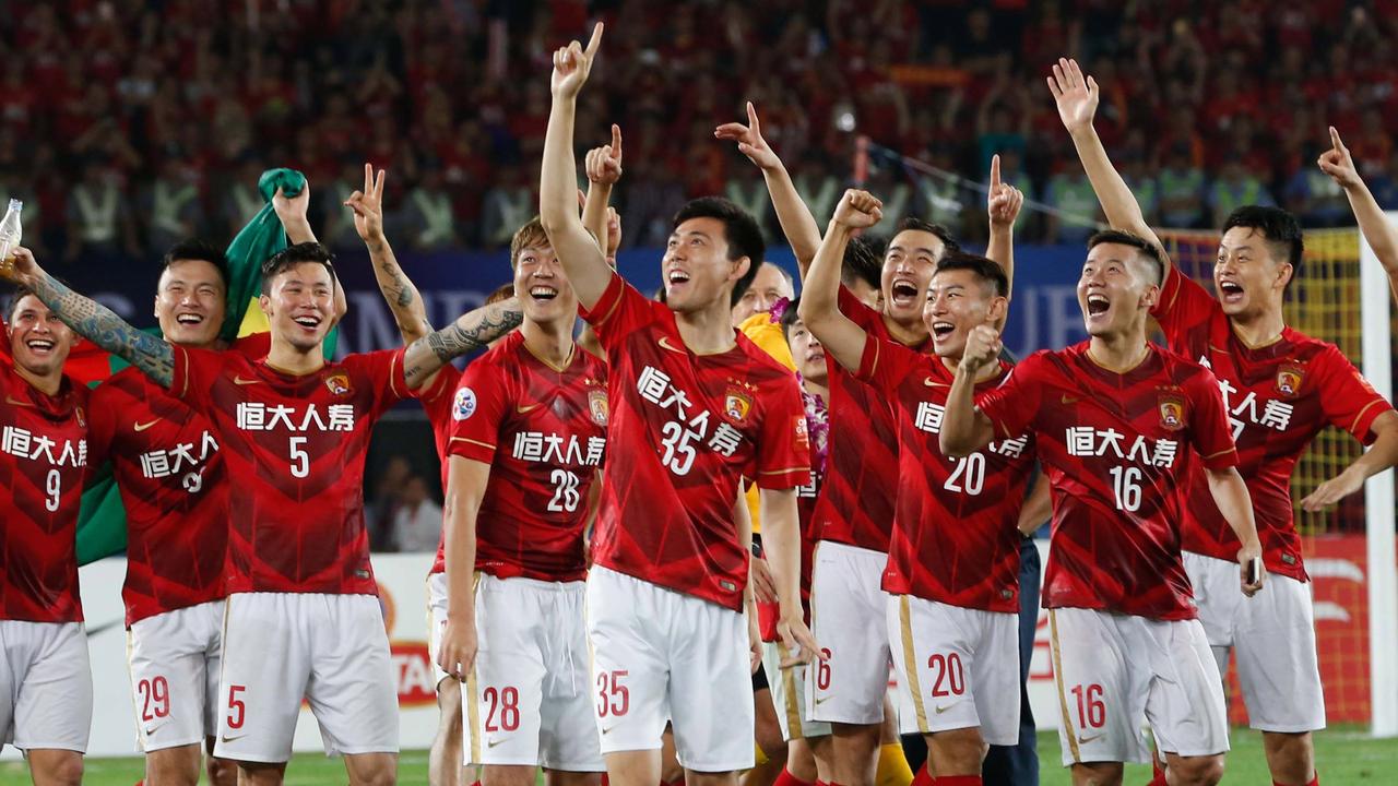 (FILES) This picture taken on November 21, 2015 shows China's Guangzhou Evergrande players celebrating their win in the AFC Champions League football final against UAE's Al Ahli in Guangzhou, in southern China's Guangdong province. The car company that sponsors the shirts of Asia's newly crowned football champions has launched legal action on November 24, against the club for changing their kit for the AFC Champions League final, the firm said. Chinese-Japanese joint venture Dongfeng Nissan paid more than 16 million USD for the season-long rights to Guangzhou Evergrande Taobao's apparel, according to China's official news agency Xinhua. CHINA OUT AFP PHOTO