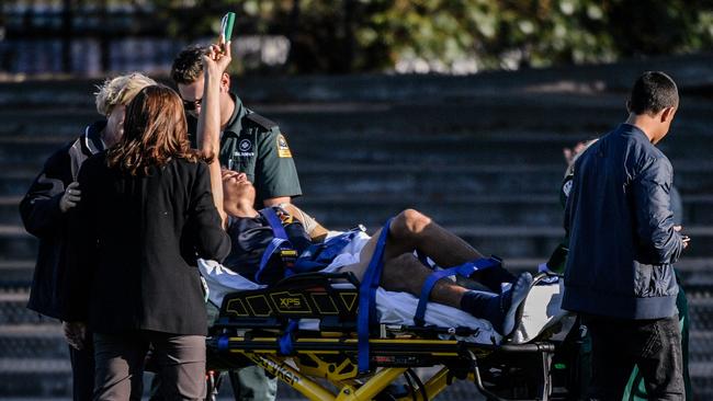 Scotch’s Ashley Johnson raises his arm to let his team know he was OK, as he was taken off the field to hospital after a nasty fall on Saturday. Picture: AAP / Morgan Sette