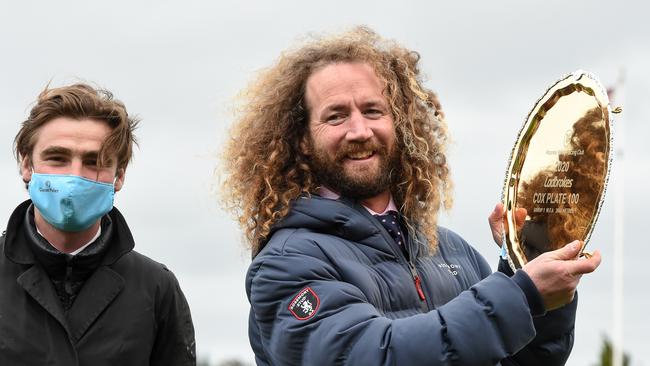 Co-trainer of Sir Dragonet Ciaron Maher holds the trophy. Picture: Getty Images