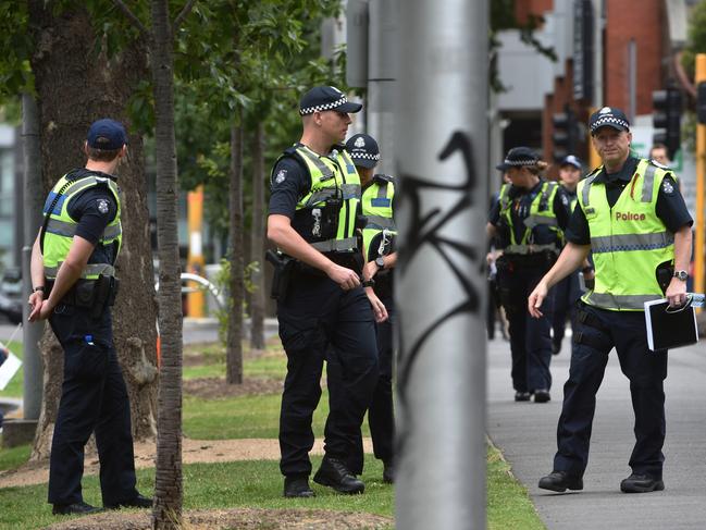 Officers gather at the cathedral as terror raids are carried out across the city. Picture: Jay Town