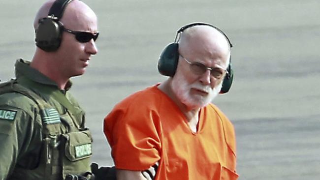 "Whitey" Bulge is escorted from a US Coast Guard helicopter after attending hearings in federal court in Boston. Picture: The Boston Herald via AP.