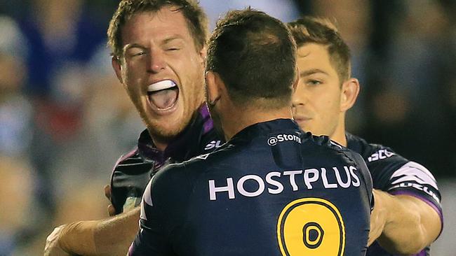 Tim Glasby celebrates a try with Storm teammates.
