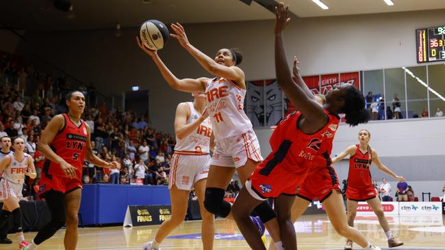 Nia Coffey of the Fire attempts to get her lay up shot out during game one of the WNBL Semi Final series between Perth Lynx and Townsville Fire at Bendat Basketball Stadium, on February 22, 2025, in Perth, Australia. (Photo by James Worsfold/Getty Images)