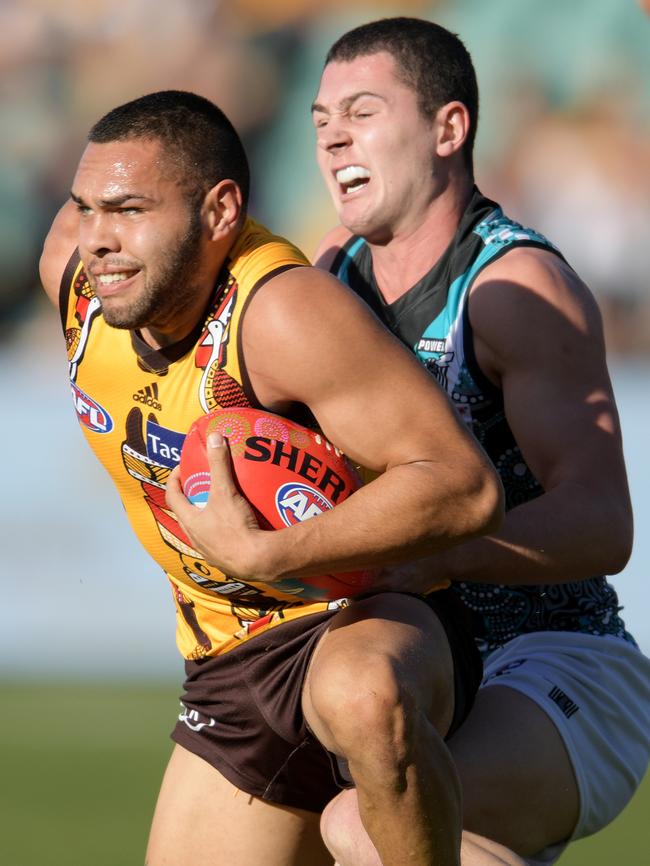 Darcy Byrne-Jones tackles former Power teammate turned Hawk Jarman Impey. Picture: AAP Image/Tracey Nearmy