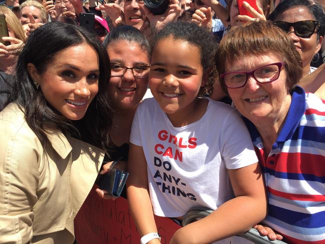 Prince Harry took this photo of Meghan with Sethunya Gibbons and her cousin Rebecca Szekeres and grandma Sharon Gibbons. Meghan told Sethunya “you look like me as a child.” Picture: Supplied