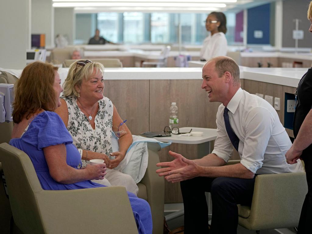 The royal rolled up his sleeves during the tour. Picture: AFP