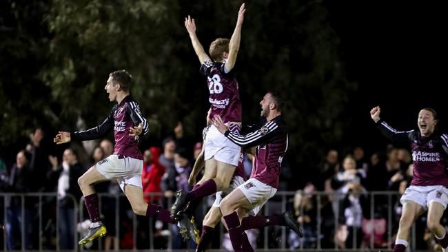 Elizabeth Downs players celebrate Jacob Leahey’s winning penalty in their FFA Cup SA victory over MetroStars. Picture: Adam Butler