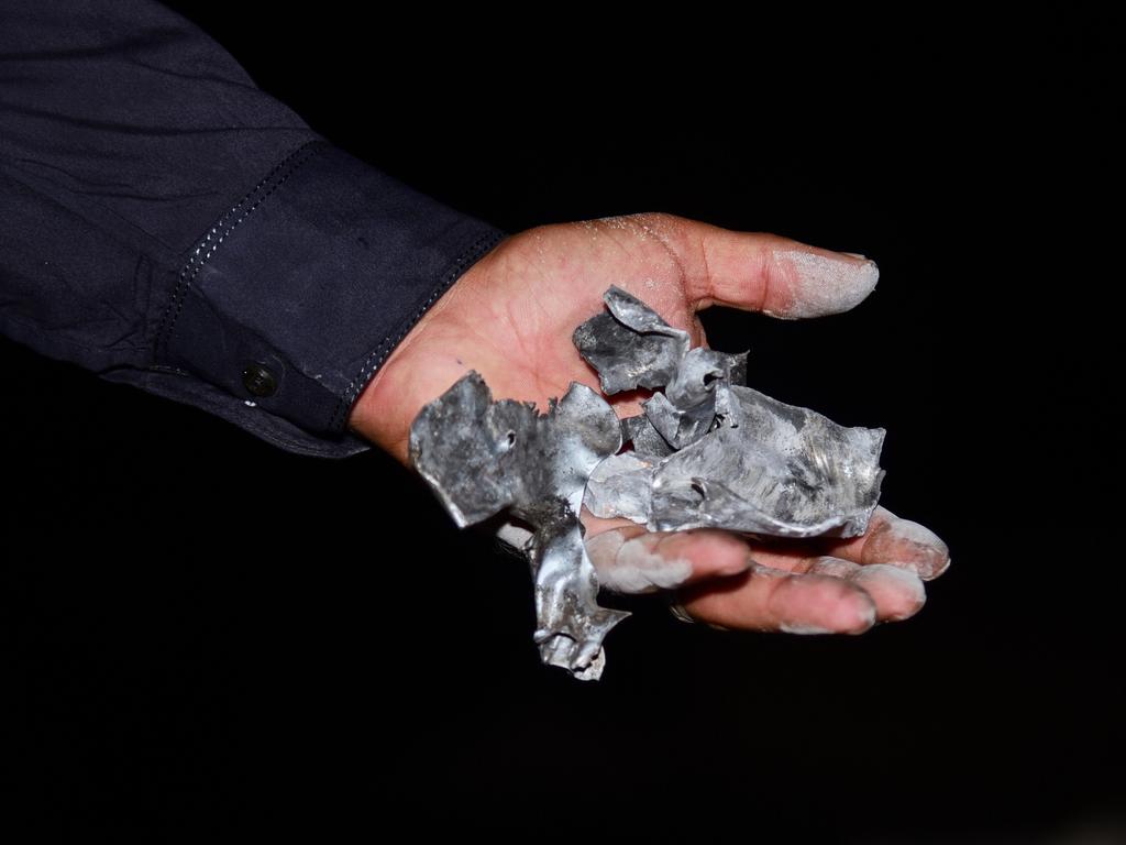 A local resident shows pieces of a suspected Indian missile at the site of the Muzaffarabad attack. Picture: AP
