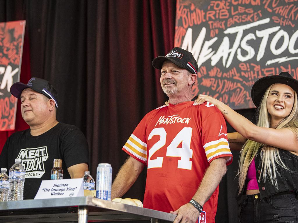 Shannon Walker (centre) prepares for the Phat Boyz Slider Throwdown eating competition at Meatstock at Toowoomba Showgrounds, Sunday, March 10, 2024. Picture: Kevin Farmer