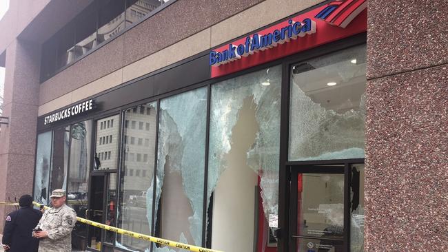 Tape closes off broken windows at businesses in Northwest Washington. Picture: AP