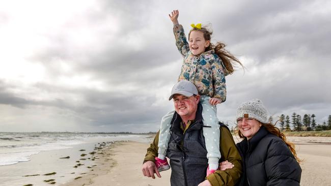 James Dickson and Holly Allen from New Zealand with their niece Lily from Adelaide at Semaphore Beach. Picture: NCA NewsWire / Brenton Edwards