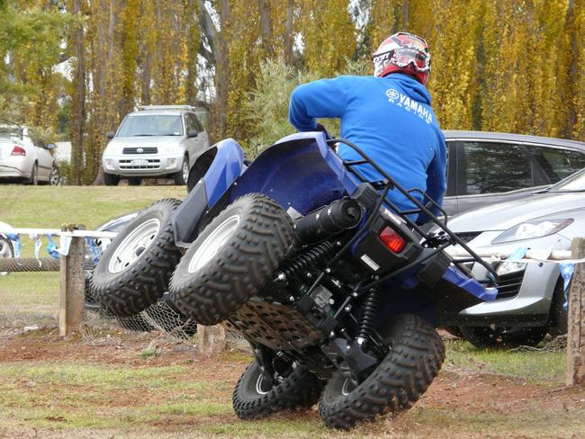 An ATV instructor demonstrates that incorrect body position can make a quad bike roll over.