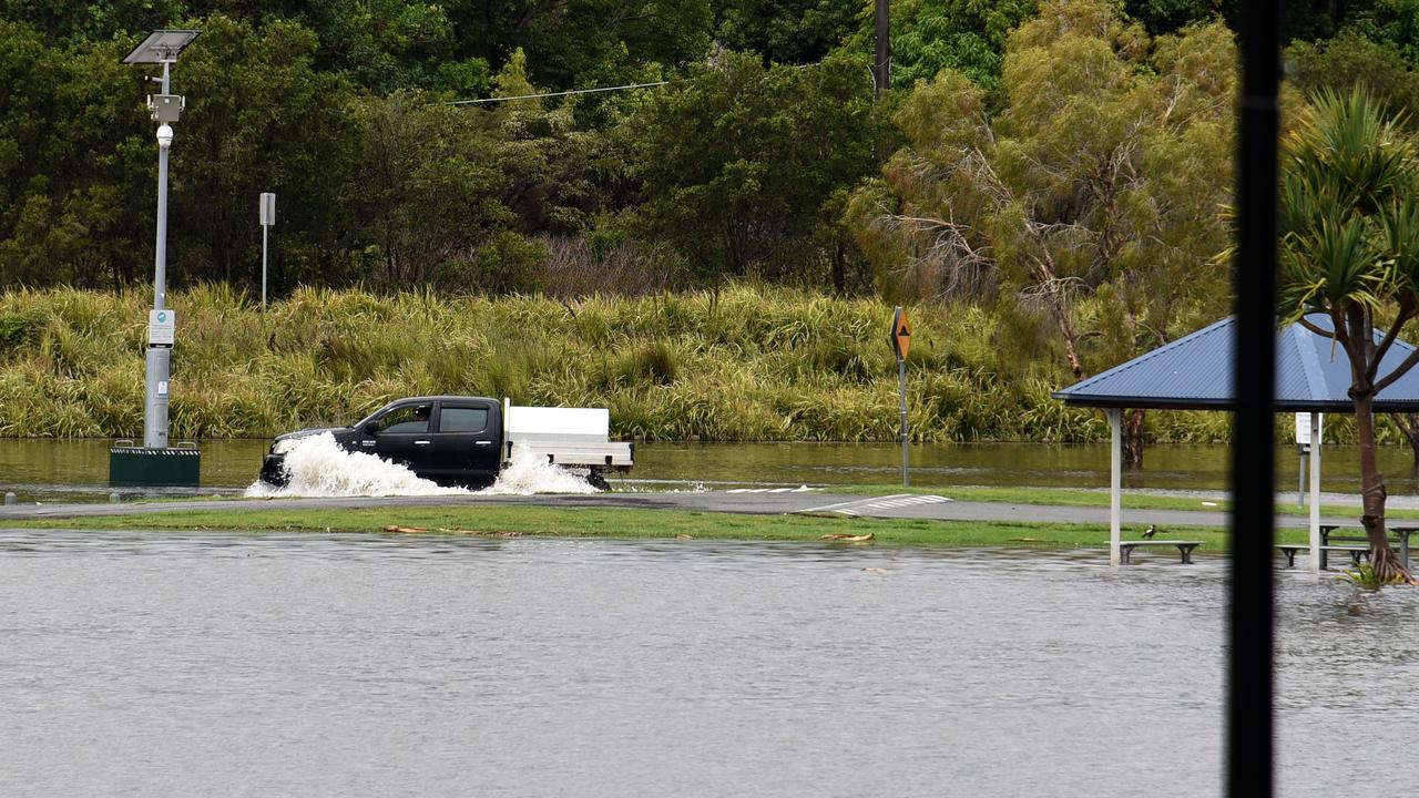 A ute drives through flood waters at Emerald Lakes. Picture: Steven Holland