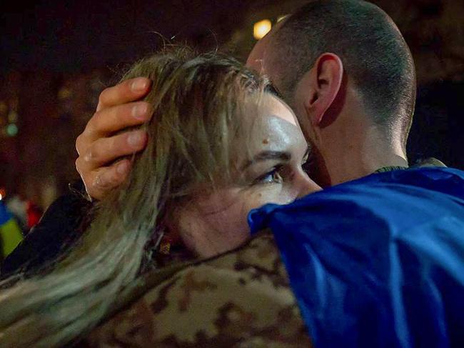 This handout photograph released by the official Telegram channel of Ukrainian President Volodymyr Zelensky on December 30, 2024, shows a Ukrainian prisoner of war embracing his wife, after an exchange at an undisclosed location, amid the Russian invasion in Ukraine. Russia and Ukraine swapped more than 300 prisoners of war on December 30, 2024 in an exchange brokered by the United Arab Emirates ahead of New Year's Eve, officials from both countries said. (Photo by HANDOUT / Telegram / @Volodymyr Zelensky / AFP) / RESTRICTED TO EDITORIAL USE - MANDATORY CREDIT "AFP PHOTO /  - / HANDOUT /  Telegram /@Volodymyr Zelensky" - NO MARKETING NO ADVERTISING CAMPAIGNS - DISTRIBUTED AS A SERVICE TO CLIENTS