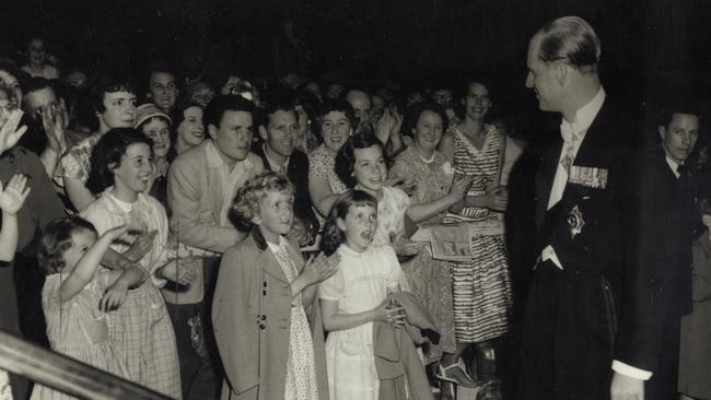 Children climbed under the barricades outside Melbourne’s Menzies Hotel to clap Prince Philip as he entered for the Olympic Banquet in 1956.