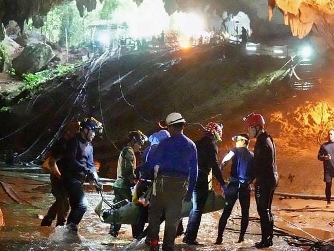 One of the members of the Wild Boars team being moved on a stretcher during the rescue operation at Tham Luang cave in Khun Nam Nang Non Forest Park. Picture: AFP