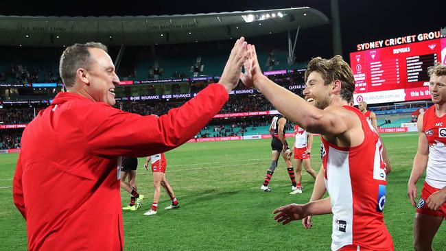 150-gamer Dane Rampe celebrates a win with coach John Longmire. Picture. Phil Hillyard.