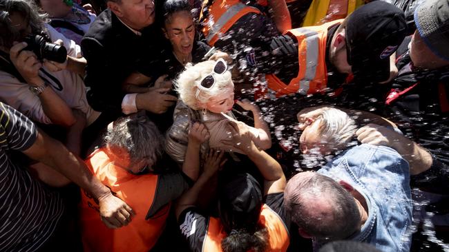 British activist Kellie-Jay Keen-Minshull aka Posie Parker is escorted from Albert Park. Picture: Dean Purcell