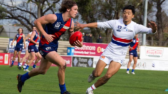 Coburg midfielder Marcus Lentini takes on Footscray's Lin Jong. Picture: Eleanor Armstrong