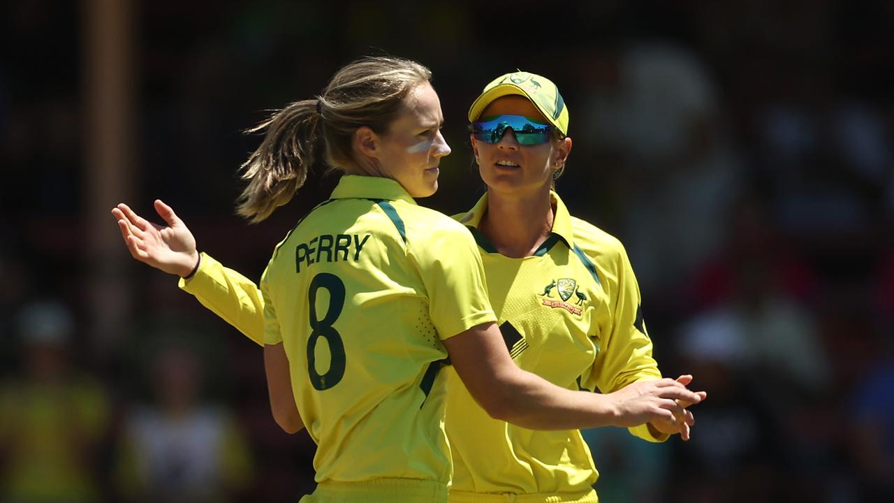 SYDNEY, AUSTRALIA - JANUARY 24: Ellyse Perry of Australia (L) celebrates with Meg Lanning of Australia after dismissing Muneeba Ali Siddiqui of Pakistan during game one of the T20 International series between Australia and Pakistan at North Sydney Oval on January 24, 2023 in Sydney, Australia. (Photo by Matt King/Getty Images)
