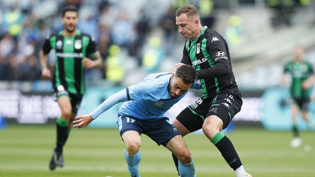 Anthony Cacares tackles Besart Berisha during Sunday’s 2-0 win for Sydney FC over Western United, where a number of Sydney fans were evicted.