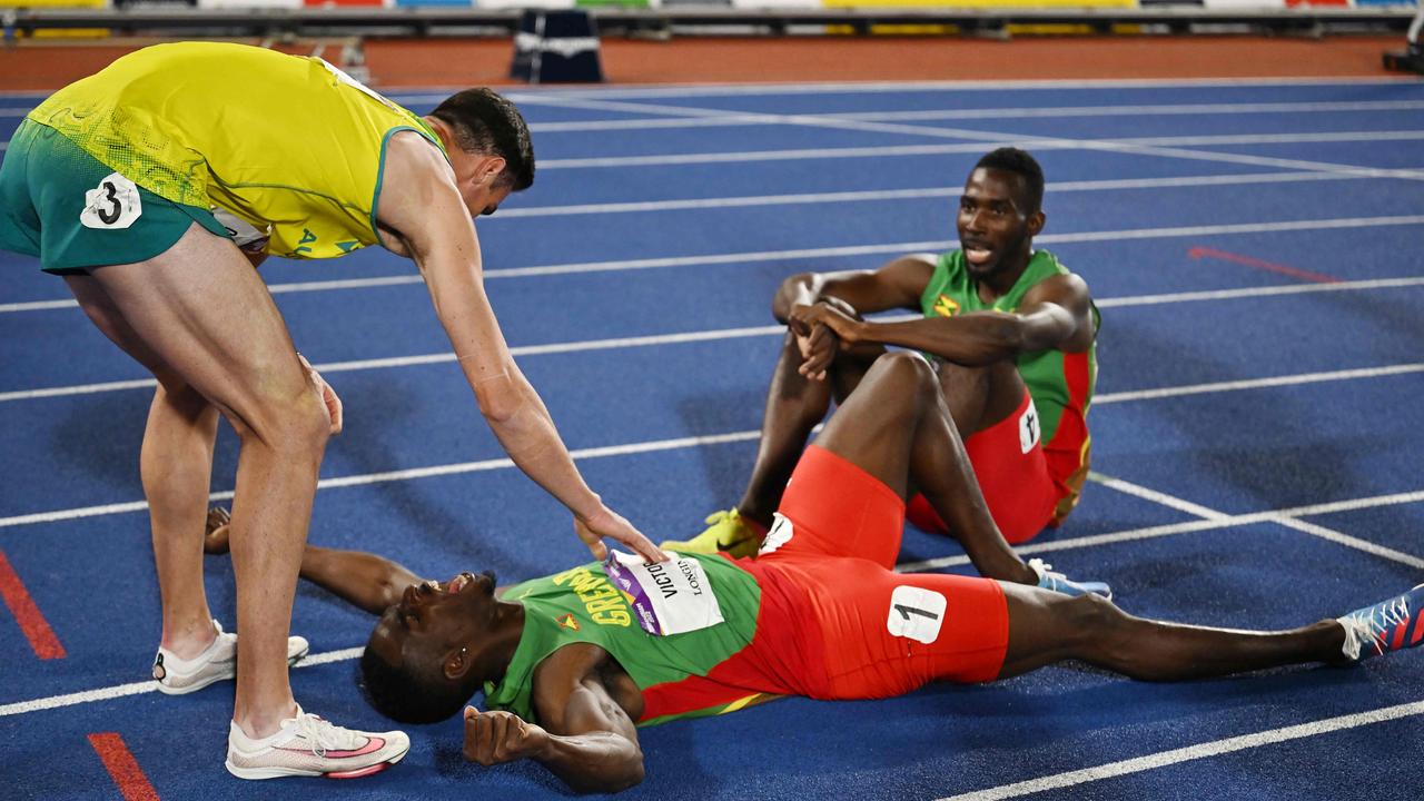 Daniel Golubovic congratulates an exhausted Lindon Victor at the finish line. Photo by Ben Stansall / AFP.