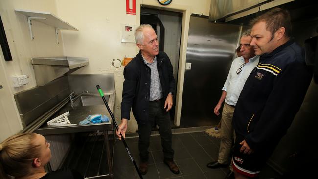 Lismore PM visit. Prime Minister Malcolm Turnbull in the Lismore CBD touring the flood damage. Owner of La Baracca Restaurant on Keen St, Steve Krieg shows the Prime Minister and local MP Kevin Hogan his damaged business.. Pic Nathan Edwards