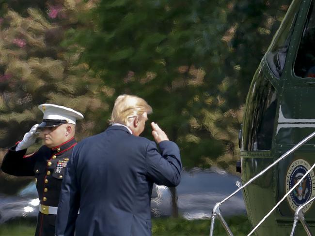 President Donald Trump salutes as he boards Marine One on the South Lawn of the White House today in Washington. Picture: AP