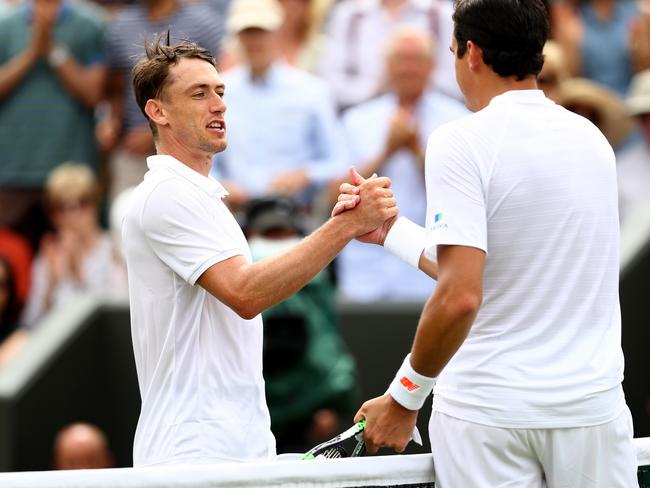 LONDON, ENGLAND - JULY 04: Milos Raonic of Canada (R) shakes hands with John Millman of Australia after their Men's Singles second round match on day three of the Wimbledon Lawn Tennis Championships at All England Lawn Tennis and Croquet Club on July 4, 2018 in London, England. (Photo by Matthew Stockman/Getty Images)