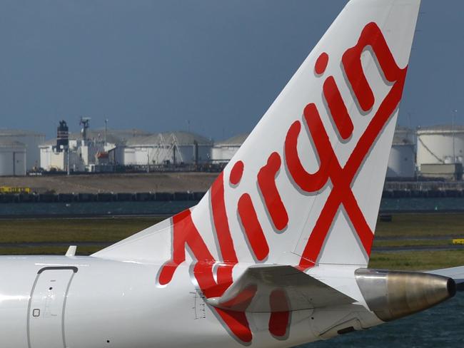 (FILES) This file photo taken on August 28, 2014 shows a Virgin Australia plane getting ready to take-off at Sydney Airport in Sydney. Virgin Australia posted a USD 69.1 million loss for the year on August 7, 2015, but said it was on track to return to profitability in 2016 as it reshapes its international business. AFP PHOTO / FILES / Peter PARKS