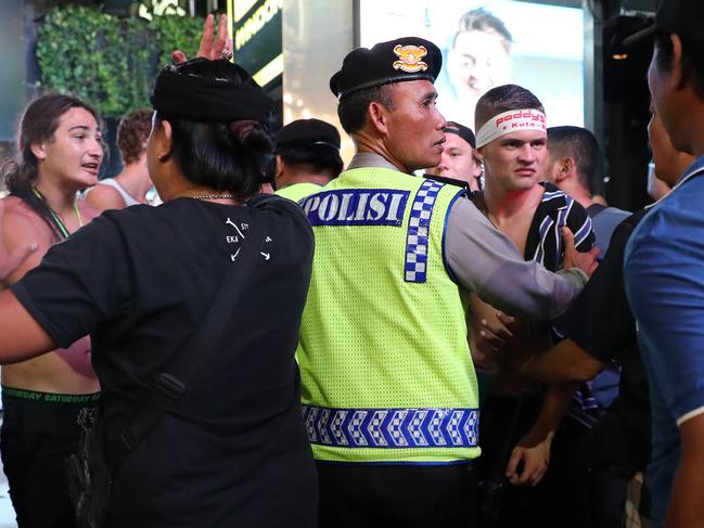 Local police intervene to break up the fight between the young Australians in Kuta. Picture: Liam Kidston