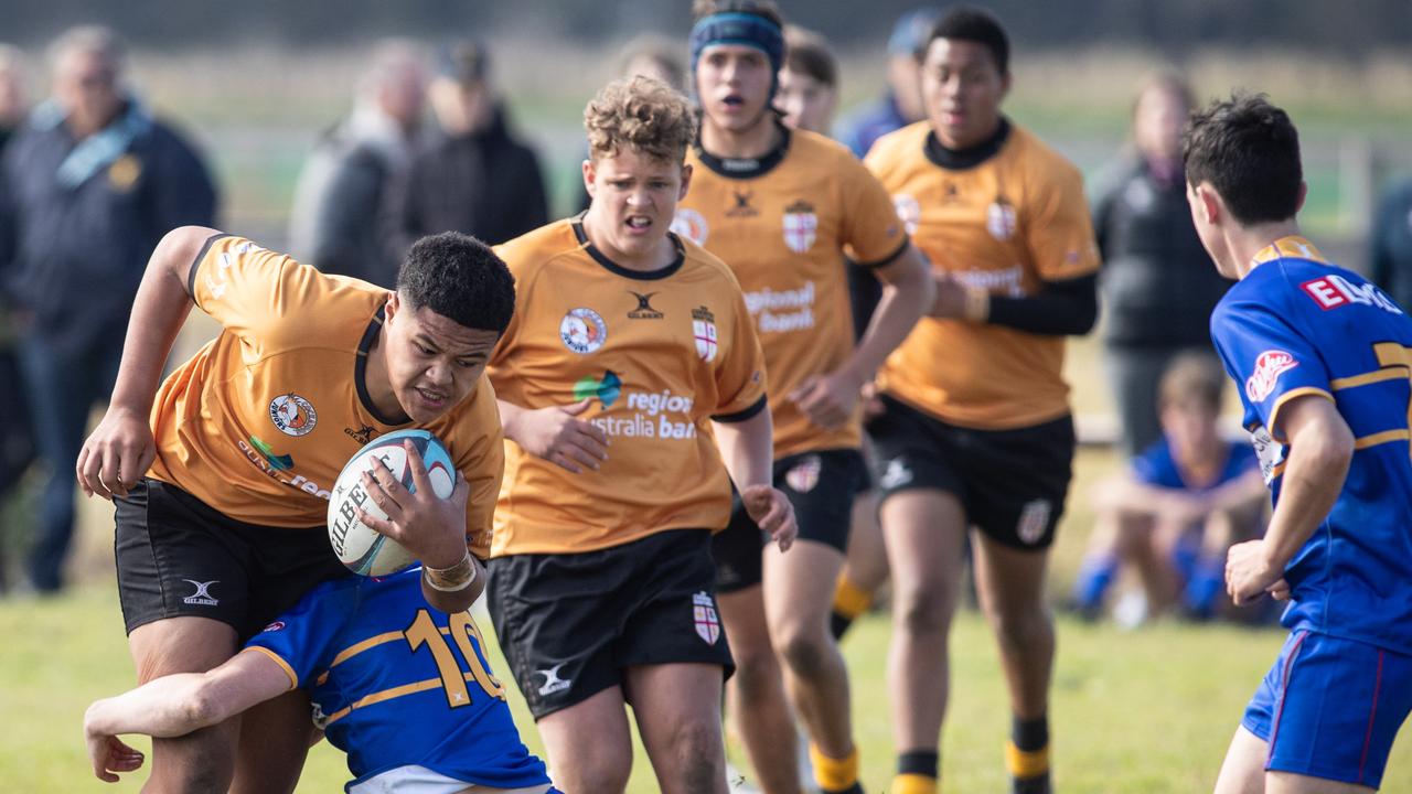 Country’s Asera Peniata is tackled by Finn Hannon in the Under 14s match. Picture: Julian Andrews