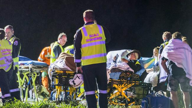 Emergency services treat injured passengers at a makeshift triage station. Picture: Jake Nowakowski