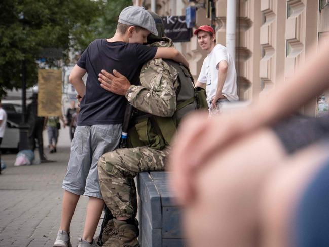 A young boy hugs a Wagner group fighter in Rostov-on-Don. Picture: AFP