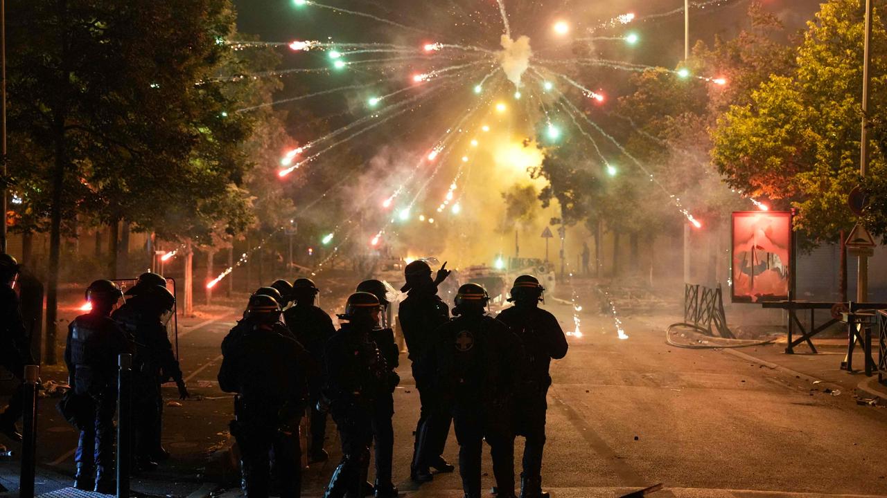 Police stand by and watch explosions in northwest Paris in early June, as protests continue across France in the aftermath of the killing by a policeman of a teenage driver in the Parisian suburb of Nanterre. Picture: Zakaria Abedlkafi/AFP