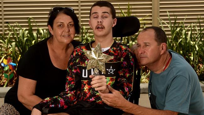 Trent Atto, with his mum Debbie Watson and dad Ray Atto at Rolad McDonald House, is recovering from a severe brain injury. Picture: Evan Morgan