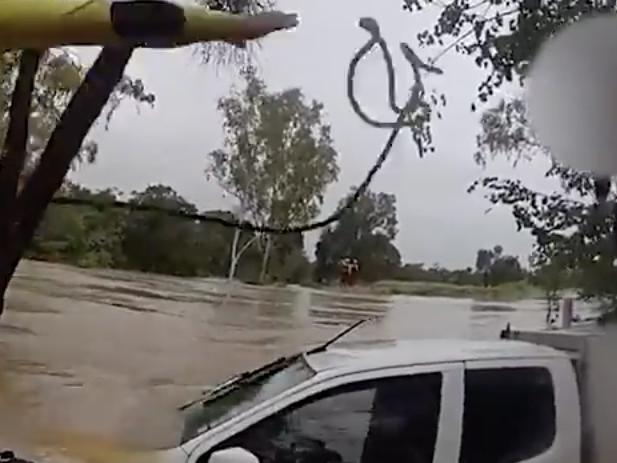 WATCH: Driver found stranded on ute roof in raging floodwaters